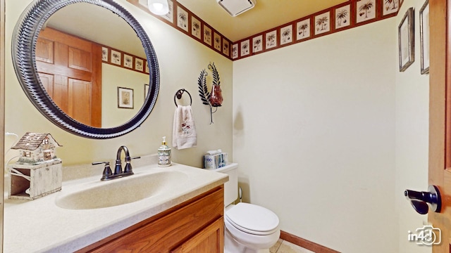bathroom featuring vanity, toilet, and tile patterned flooring