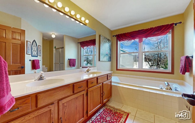 bathroom with a sink, double vanity, a stall shower, a bath, and tile patterned floors