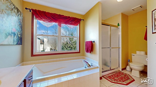 bathroom with visible vents, toilet, a shower stall, and a garden tub