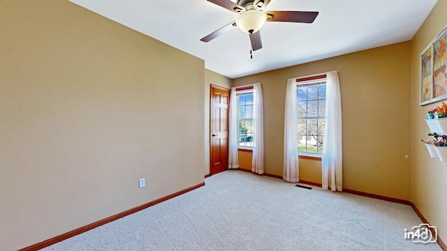 unfurnished room featuring light colored carpet, visible vents, and baseboards