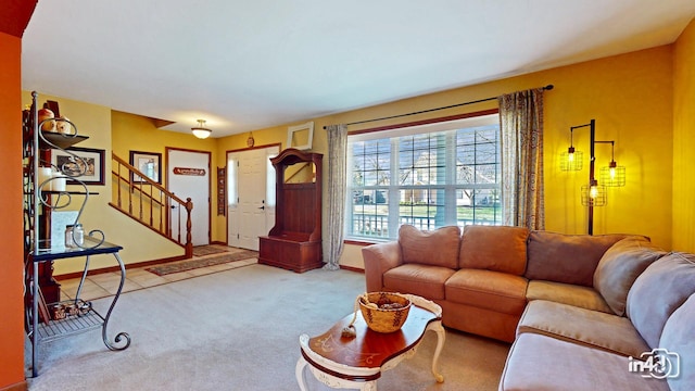 carpeted living room featuring baseboards and stairway