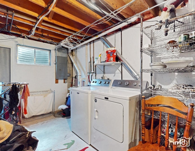 clothes washing area featuring independent washer and dryer, electric panel, and laundry area