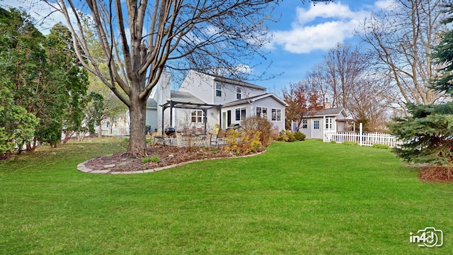 view of yard featuring an outdoor structure, a patio, and fence