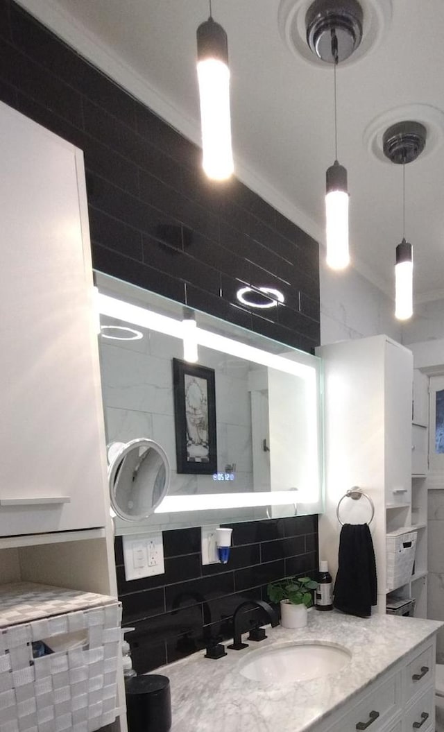 bathroom with vanity, tasteful backsplash, and crown molding