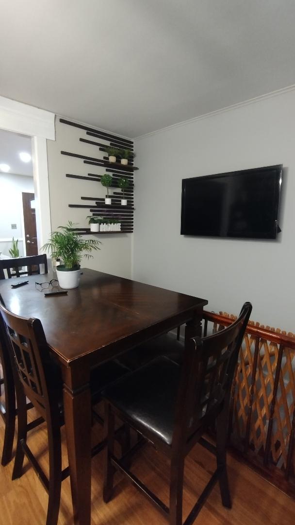 dining space with wood finished floors