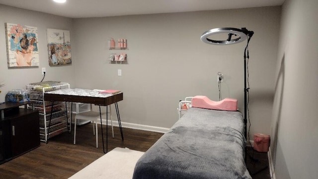 bedroom with dark wood-style floors and baseboards