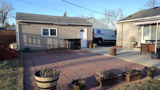 view of patio / terrace featuring an outbuilding and fence