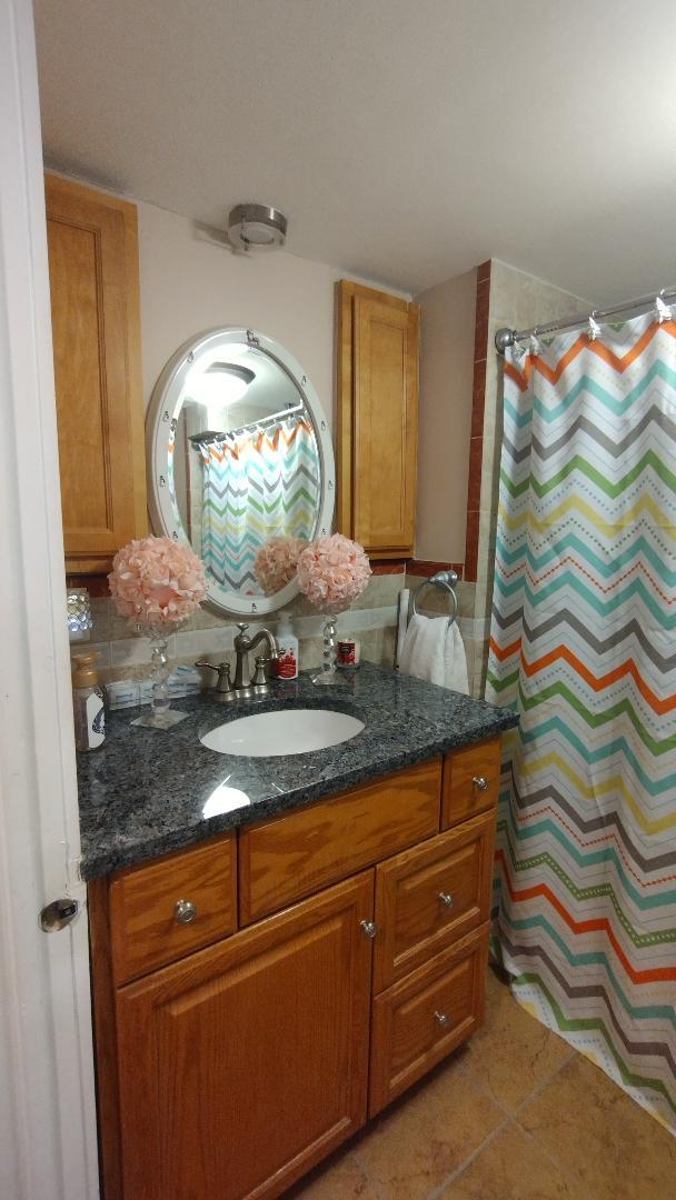 full bath featuring tile patterned floors, a shower with shower curtain, backsplash, and vanity