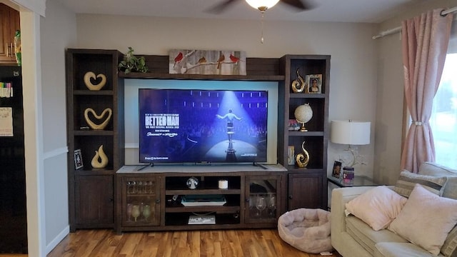 living room with wood finished floors and ceiling fan