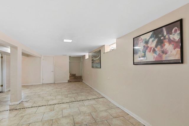 finished below grade area featuring stairs and baseboards
