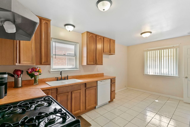 kitchen with light countertops, white dishwasher, gas stove, ventilation hood, and a sink