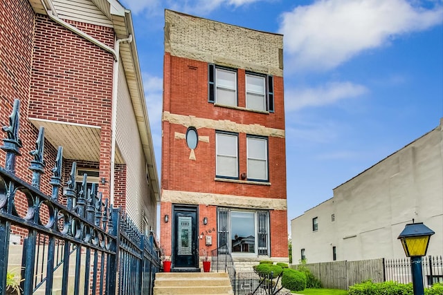 4364 S Oakenwald Ave, Chicago, IL 60653 - view of front of house with brick siding, fence, and entry steps