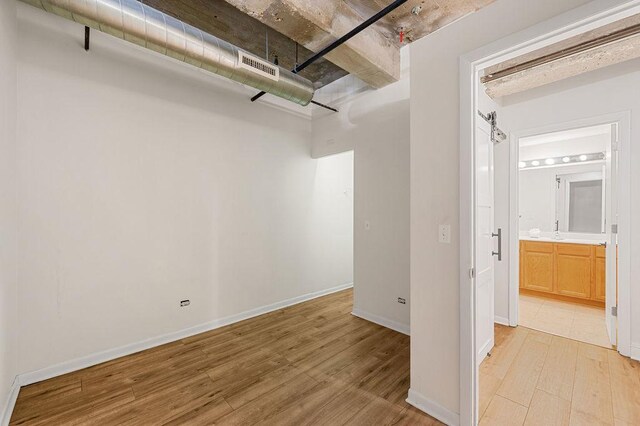 interior space featuring baseboards, visible vents, and light wood-style flooring