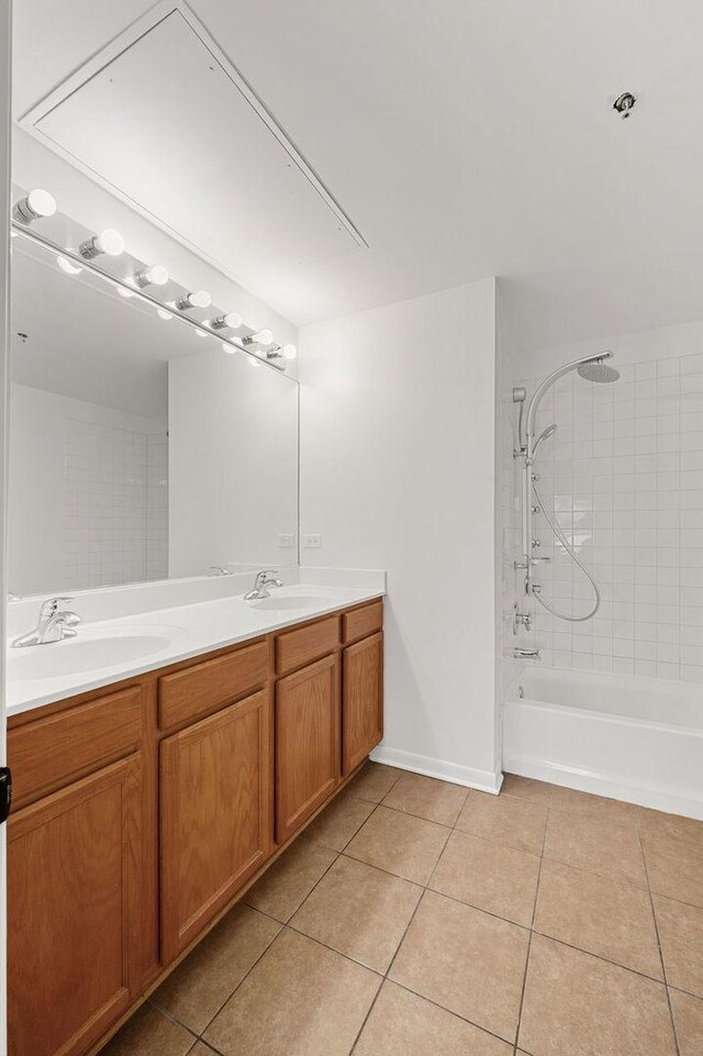 bathroom with double vanity, a sink, tile patterned floors, and shower / bathtub combination