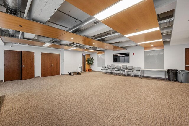below grade area featuring visible vents and carpet floors