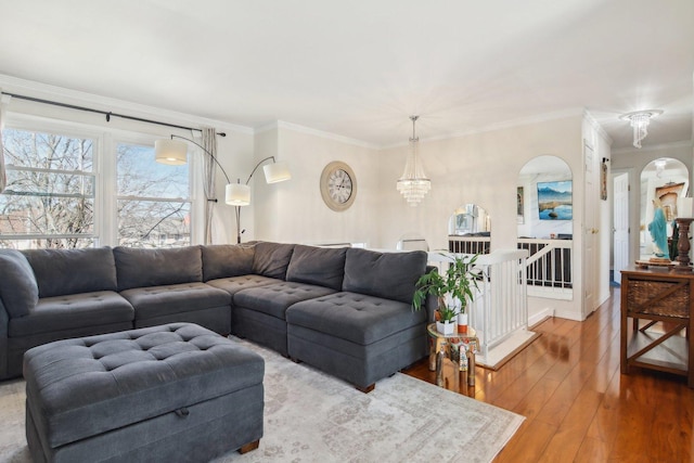 5621 Fernwood Ct, Matteson, IL 60443 - living room with hardwood / wood-style flooring, ornamental molding, arched walkways, and a chandelier