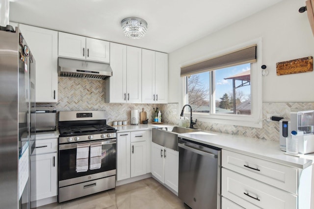 5621 Fernwood Ct, Matteson, IL 60443 - kitchen with appliances with stainless steel finishes, under cabinet range hood, a sink, light countertops, and backsplash