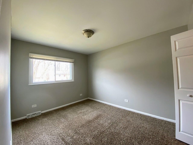 unfurnished room featuring carpet floors, baseboards, and visible vents