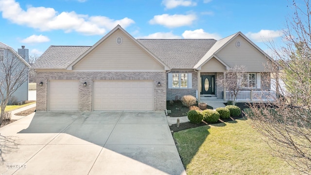 ranch-style home featuring driveway, roof with shingles, brick siding, a front lawn, and a garage