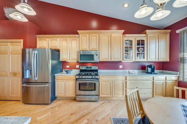 kitchen featuring light brown cabinets, light countertops, and stainless steel appliances
