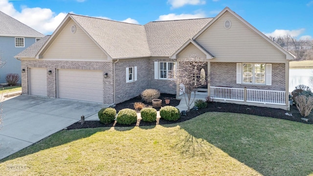 view of front of house featuring a front yard, concrete driveway, an attached garage, brick siding, and a porch