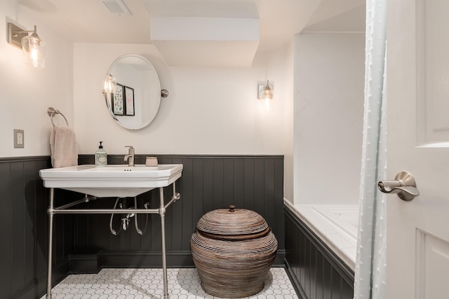 bathroom featuring vanity, wainscoting, visible vents, and tile patterned flooring