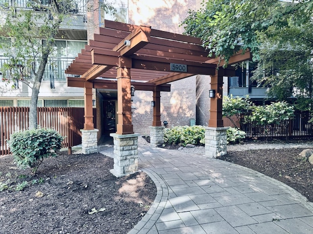 view of community featuring a pergola and fence