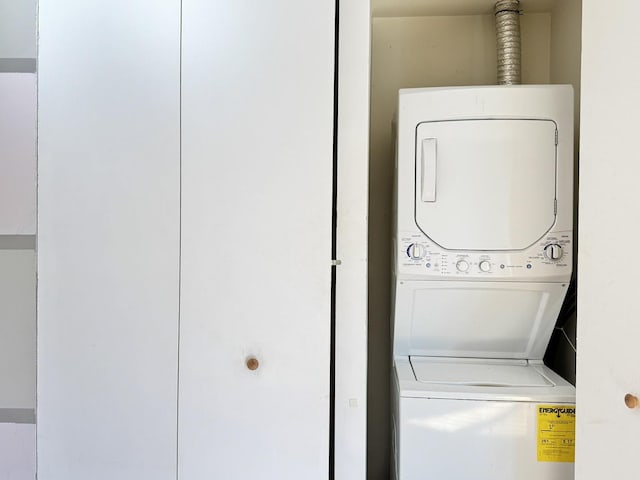 laundry room featuring stacked washing maching and dryer and laundry area
