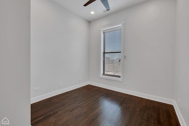 spare room with a ceiling fan, visible vents, recessed lighting, dark wood-style flooring, and baseboards