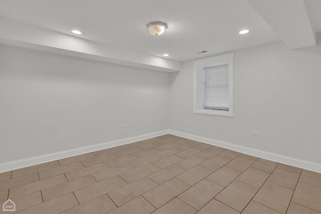 finished basement with visible vents, baseboards, and recessed lighting