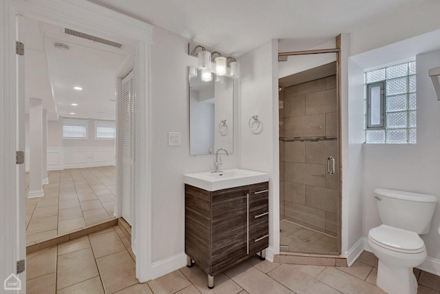 full bath featuring a shower stall, vanity, tile patterned flooring, visible vents, and toilet