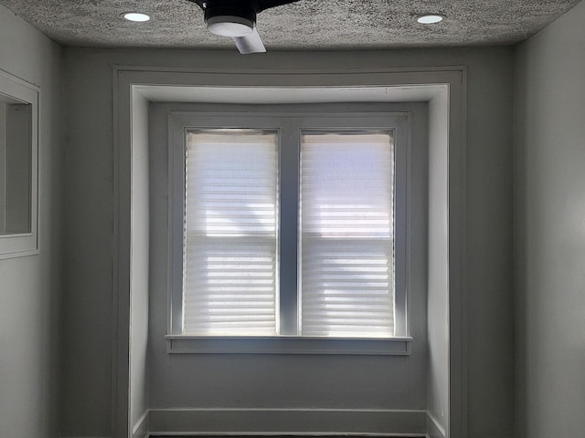 interior details featuring a textured ceiling