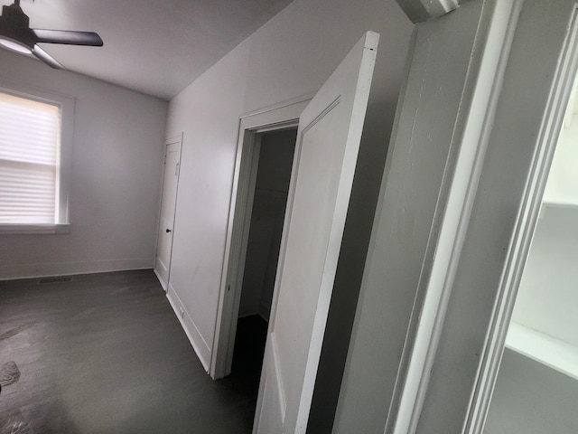 corridor with baseboards and visible vents