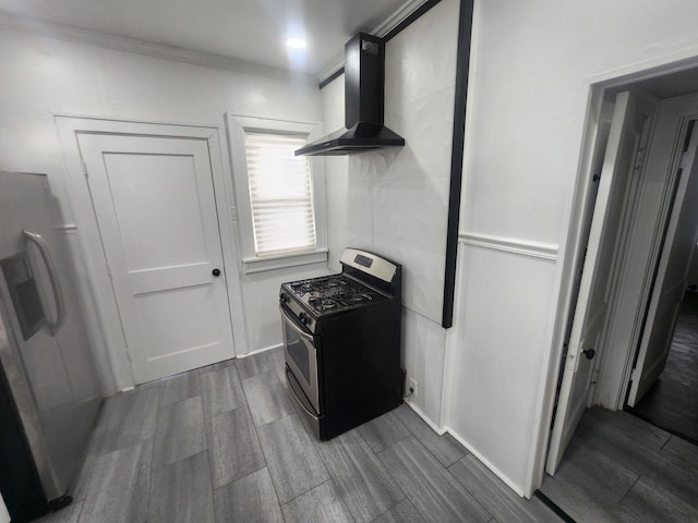 kitchen with wall chimney range hood, appliances with stainless steel finishes, crown molding, and wood tiled floor