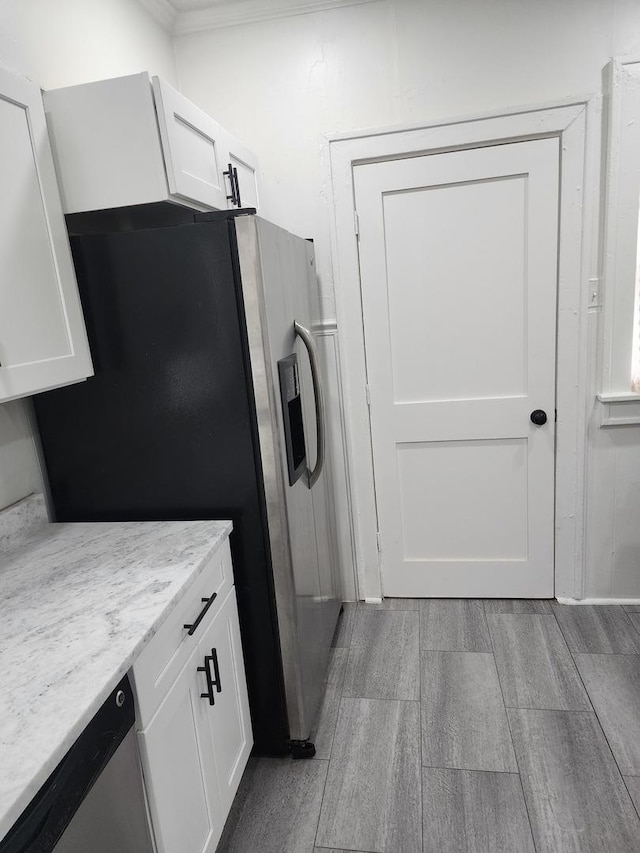 kitchen featuring white cabinets, appliances with stainless steel finishes, and light stone counters