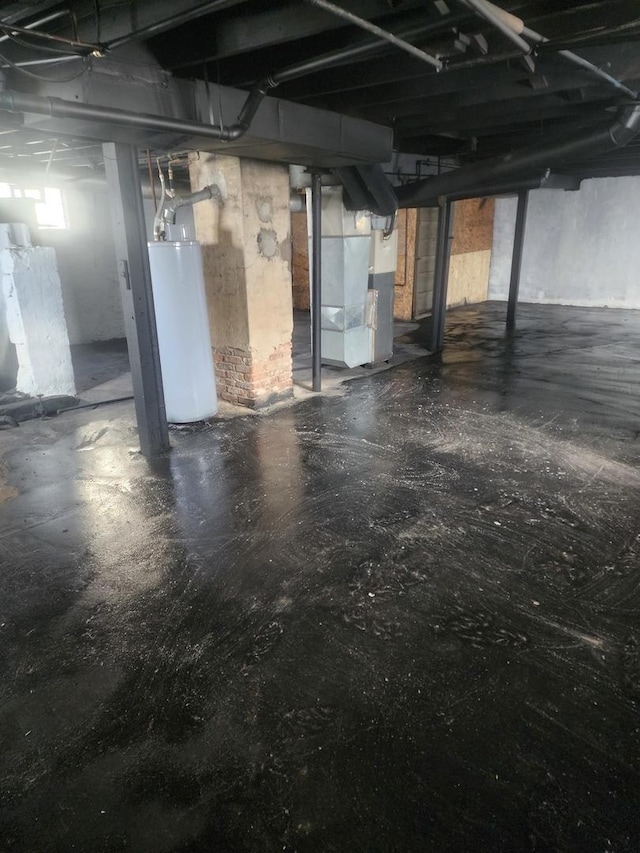 below grade area featuring water heater and heating unit
