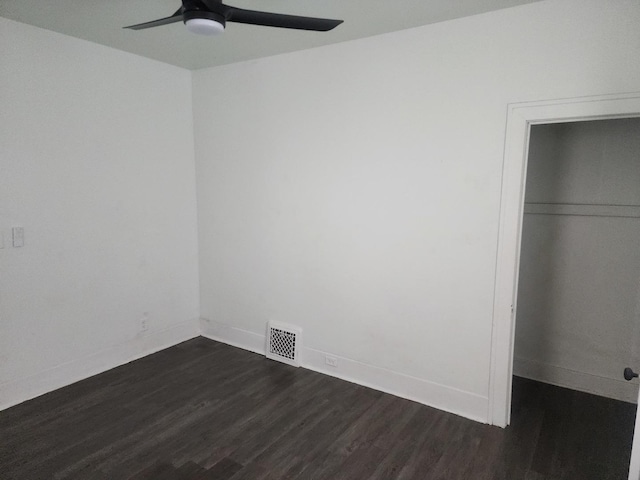 unfurnished bedroom with baseboards, dark wood-style floors, ceiling fan, visible vents, and a closet