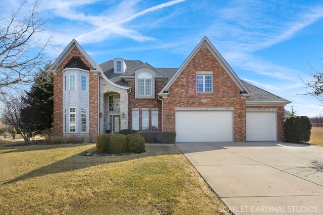 view of front of house with brick siding, a front yard, driveway, and roof with shingles