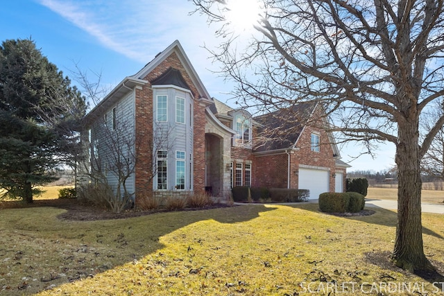 traditional-style house featuring brick siding, driveway, an attached garage, and a front lawn