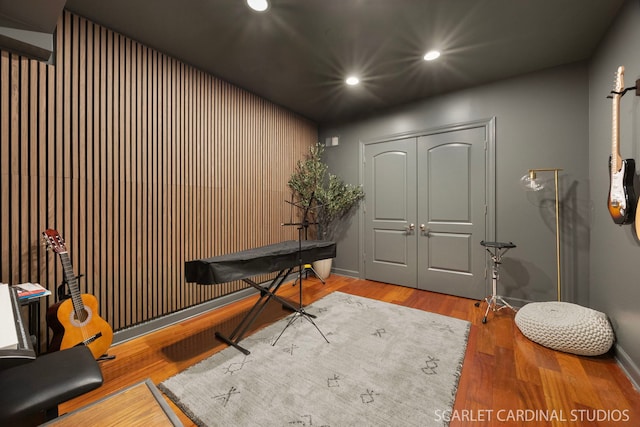 misc room featuring baseboards, wood finished floors, and recessed lighting