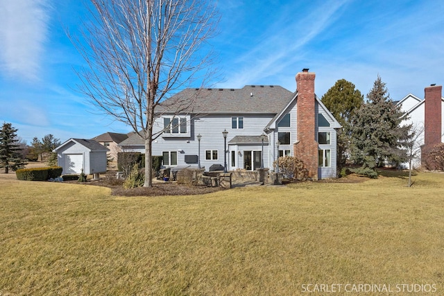 rear view of property with an outdoor structure, a chimney, a patio, a yard, and a storage shed