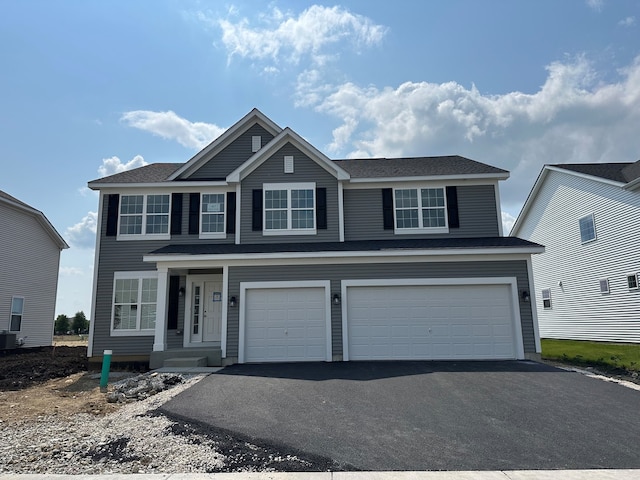 627 Henry Ln, Oswego, IL 60543 - traditional-style house with an attached garage and asphalt driveway