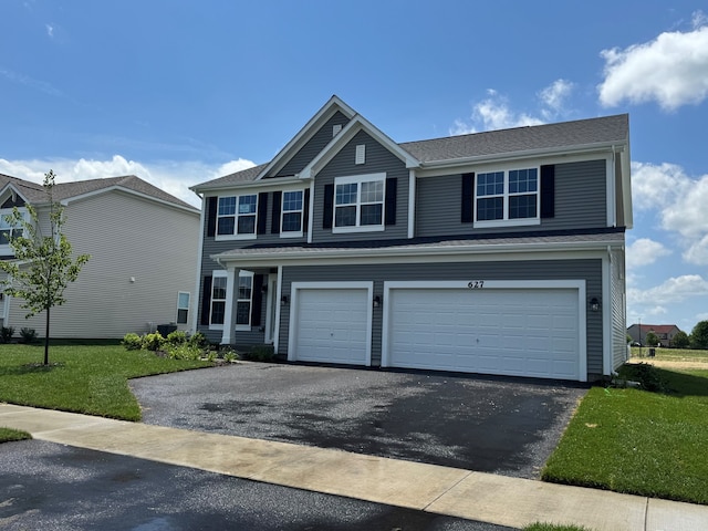 627 Henry Ln, Oswego, IL 60543 - view of front of home featuring asphalt driveway, a garage, and a front lawn