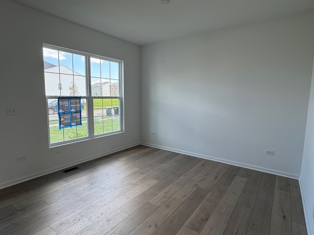 627 Henry Ln, Oswego, IL 60543 - empty room featuring healthy amount of natural light and dark wood finished floors