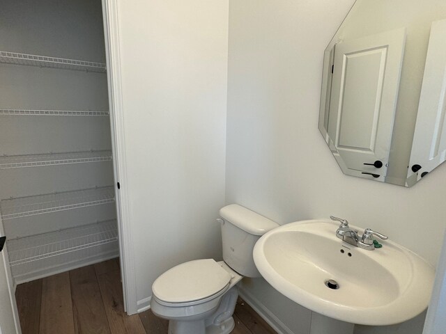 627 Henry Ln, Oswego, IL 60543 - bathroom featuring a sink and wood finished floors