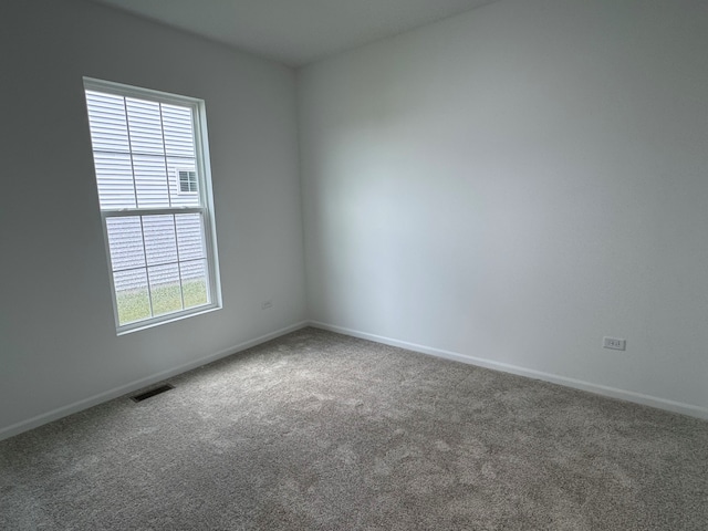 627 Henry Ln, Oswego, IL 60543 - spare room featuring carpet flooring and baseboards