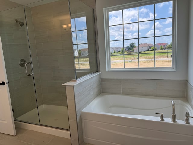 627 Henry Ln, Oswego, IL 60543 - bathroom with a stall shower, a bath, and tile patterned floors