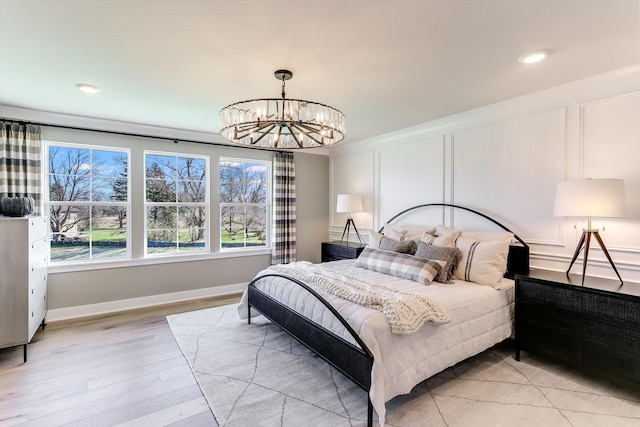 627 Henry Ln, Oswego, IL 60543 - bedroom featuring a chandelier, light wood-style flooring, a decorative wall, and recessed lighting