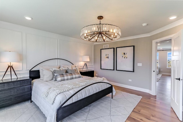 627 Henry Ln, Oswego, IL 60543 - bedroom with a chandelier, light wood-style floors, recessed lighting, and ornamental molding