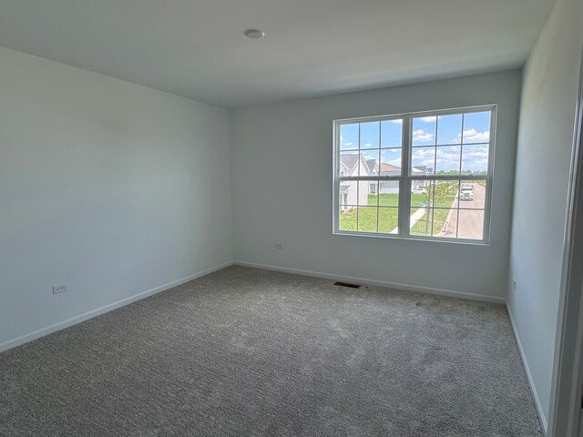 627 Henry Ln, Oswego, IL 60543 - carpeted empty room featuring baseboards